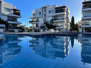 a swimming pool in front of some apartment buildings at RiX Sunny Apartments in Kyrenia