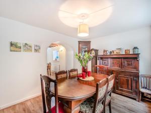 a dining room with a wooden table and chairs at Ty Newydd Y Graig - 28017 in Tremeirchion