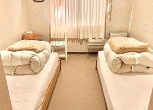 Ένα ή περισσότερα κρεβάτια σε δωμάτιο στο たんばら高原 ペンション スターガーデン