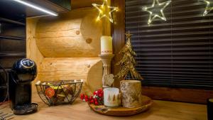 a table with a candle and christmas decorations on it at Chata Czego Dusza Pragnie in Zachełmie
