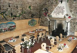 a restaurant with tables and chairs and a fireplace at Gasthof Pflamminger in Wörth an der Donau