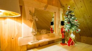 a christmas tree in a room with a mirror at Chata Czego Dusza Pragnie in Zachełmie +46 photos