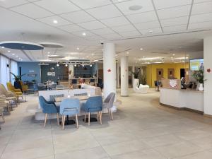 a lobby with chairs and a table in a hospital at DOMITYS - La Via Domitia in Gap