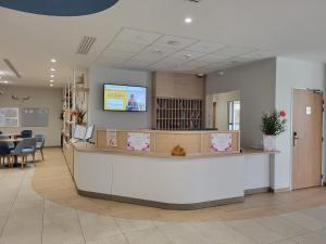 a waiting room with a reception counter in a hospital at DOMITYS - La Via Domitia in Gap