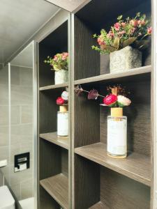 a bathroom with wooden shelves with flowers in them at an emotional view of the sea at sunrise in Kwangan-dong