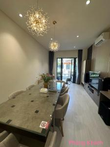 a living room with a dining room table with chairs at Ho tram Beach Villa Biển Xuyên Mộc in Xuyên Mộc