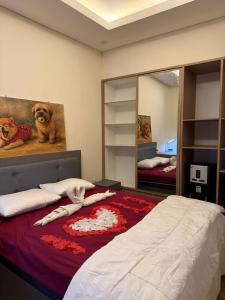 a bedroom with a bed and a large mirror at villa koku kuta in Legian +1 photo