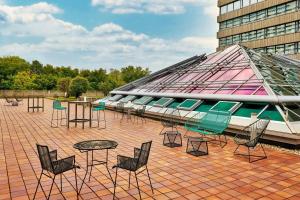a group of chairs and tables and a building at The Westin Grand Munich in Munich