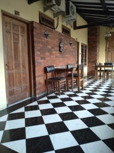 a dining room with a black and white checkered floor at Duta Kencana in Timuran