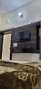 a flat screen tv on a wall in a room at Hotel Premshanti Orchha in Orchha