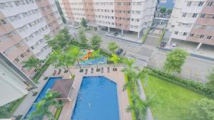 an overhead view of a swimming pool with palm trees at Resort Condo in Trece Martires Cavite in Trece Martires