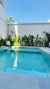 a swimming pool in front of a building at LÚA de ROSY HOI AN in Hiếu Nhơn