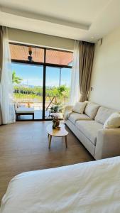 a living room with a couch and a table at LÚA de ROSY HOI AN in Hiếu Nhơn +45 photos