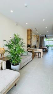 a living room with a couch and a table at LÚA de ROSY HOI AN in Hiếu Nhơn