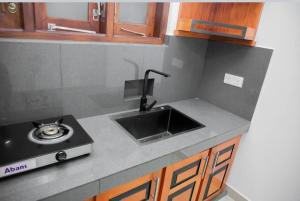 a kitchen counter top with a sink and a sink at Nade Villas Galle in Galle