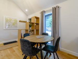a dining room with a table and chairs and a window at Rinstone Lodge in Thornton Dale +13 photos