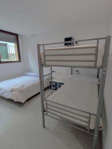 a bedroom with two bunk beds and a bed at Albergue Pundak Valle del Jerte in Cabezuela del Valle +17 photos