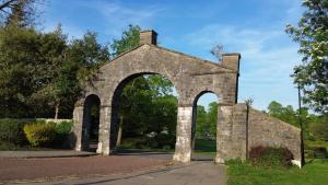 an old stone building with an arch way at Mint Cottage - pet friendly house in Kendal in Kendal
