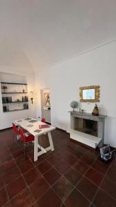 a living room with a table and a fireplace at il Casale di Adriana in Grugliasco