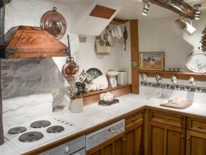 a kitchen with a stove and a counter top at Threshing Barn - Kza in Glaisdale