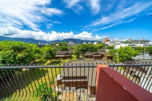 a balcony with a table and a view of a city at Yunhua B&B in Hualien City