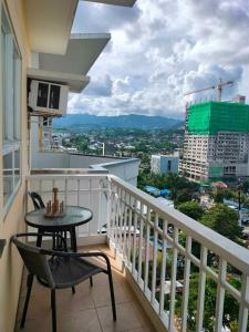 a balcony with a table and chairs and a view at Penthouse A Near IT Park in Cebu City