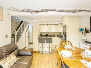 a living room and kitchen with a wooden table at Church View in Barmby on the Marsh