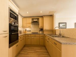 a kitchen with a sink and a stove top oven at 13 Great Cliff in Dawlish +8 photos