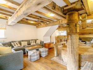 a living room with a couch and a table at The Water Mill in Bradbourne