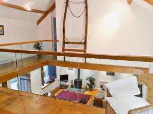 an overhead view of a living room with a spiral staircase at Shaplands Barn in Cold Ashton