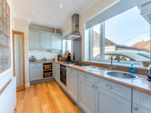a kitchen with a sink and a window at Beach Haven - Uk42241 in Littlestone-on-Sea