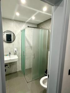 a bathroom with a shower and a toilet and a sink at Prenoćište Vozač in Jajce