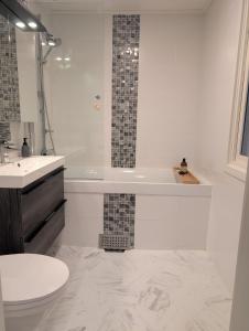 a bathroom with a tub and a toilet and a sink at Home in Vingåker in Vingåker