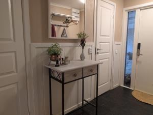 a hallway with a console table with plants on it at Home in Vingåker in Vingåker