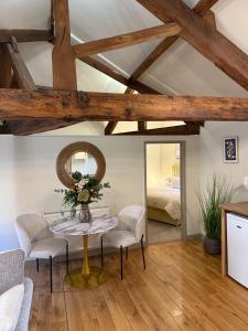 a living room with a table and chairs and a bed at Hayloft studio apartment in Warwick