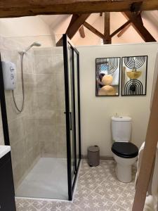 a bathroom with a shower and a toilet at Hayloft studio apartment in Warwick