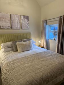 a bedroom with a bed with a white bedspread at Hayloft studio apartment in Warwick