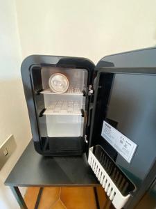 a small black refrigerator sitting on top of a table at Affittacamere La Quiete in Arona +3 photos