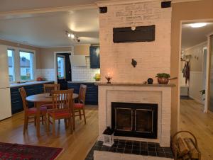 a living room with a fireplace and a table and chairs at Home in Vingåker in Vingåker