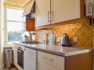 a kitchen with a sink and a stove top oven at Fell View in Ambleside