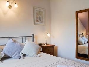 a bedroom with a bed and a mirror at Fell View in Ambleside