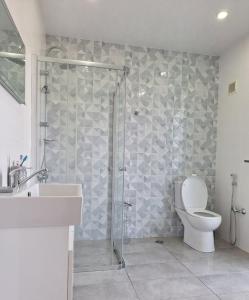 a bathroom with a shower with a toilet and a sink at Tsitadel in Zugdidi