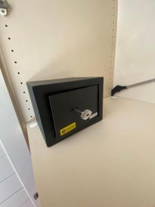 a small tv on a wall in a room at Affittacamere La Quiete in Arona