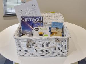 a white basket sitting on top of a table at Little Trevose in Padstow