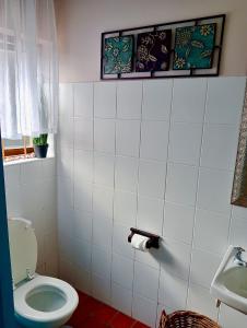 a bathroom with a toilet and a sink at Gemma in Mossel Bay