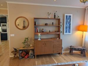 a room with a wooden cabinet and a mirror at Home in Vingåker in Vingåker +18 photos