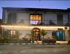 a man standing in front of a building at night at Siki Hotel in Saint-Louis