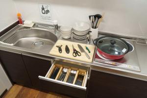 a kitchen counter top with a sink and a counter top at YUFU-Inn プライベートな露天風呂付き-由布院駅徒歩2分 in Yufuin +57 photos