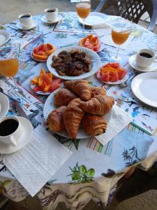 a table with plates of pastries and fruit on it at Résidence des cascades in Surinam