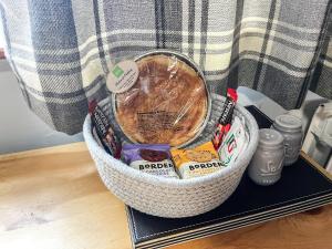 a basket filled with candy on a table at Haddon Cottage - Uk40270 in Bakewell